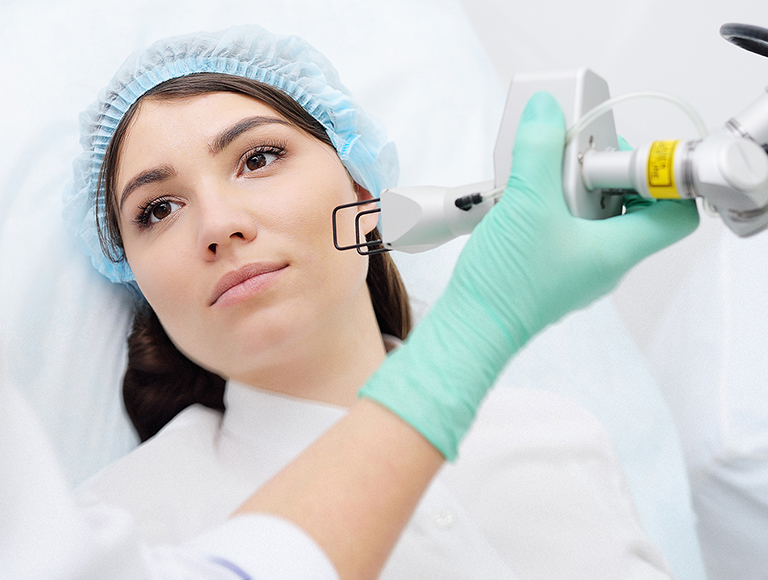 dermatologist conducts a laser skin rejuvenation procedure for a patient